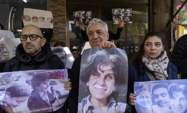 Relatives take part in a protest demanding the whereabouts of four activists who disappeared during the war between opposition groups and former President Bashar Assad's forces, in Douma, Syria, Wednesday, Jan. 1, 2025. (AP Photo/Mosa'ab Elshamy)