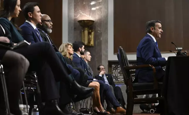 John Ratcliffe, seated right, President-elect Donald Trump's choice to be the Director of the Central Intelligence Agency, appears before the Senate Intelligence Committee for his confirmation hearing, at the Capitol in Washington, Wednesday, Jan. 15, 2025. (AP Photo/John McDonnell)