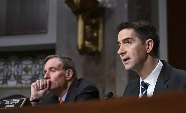Chairman of the Senate Intelligence Committee Sen. Tom Cotton, R-Ark., right, with Vice Chairman Sen. Mark Warner, D-Va., speak with John Ratcliffe, President-elect Donald Trump's choice to be the Director of the Central Intelligence Agency, before the Senate Intelligence Committee for his confirmation hearing, at the Capitol in Washington, Wednesday, Jan. 15, 2025. (AP Photo/John McDonnell)