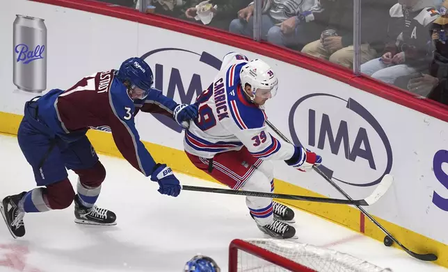 New York Rangers center Sam Carrick, right, fights for control of the puck as Colorado Avalanche defenseman John Ludvig covers in the first period of an NHL hockey game Tuesday, Jan. 14, 2025, in Denver. (AP Photo/David Zalubowski)
