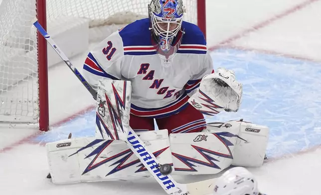 New York Rangers goaltender Igor Shesterkin makes a stick save in the first period of an NHL hockey game against the Colorado Avalanche Tuesday, Jan. 14, 2025, in Denver. (AP Photo/David Zalubowski)