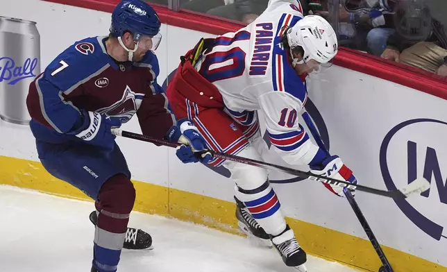 Colorado Avalanche defenseman Devon Toews, left, checks New York Rangers left wing Artemi Panarin as he collects the puck in the first period of an NHL hockey game Tuesday, Jan. 14, 2025, in Denver. (AP Photo/David Zalubowski)