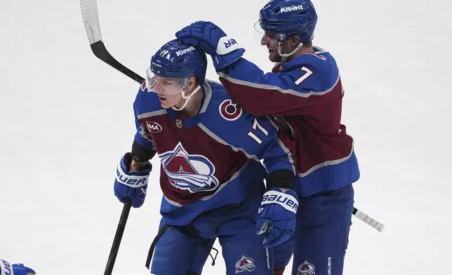 Colorado Avalanche defenseman Devon Toews, right, congratulates center Parker Kelly after he scored a goal in the first period of an NHL hockey game against the New York Rangers Tuesday, Jan. 14, 2025, in Denver. (AP Photo/David Zalubowski)