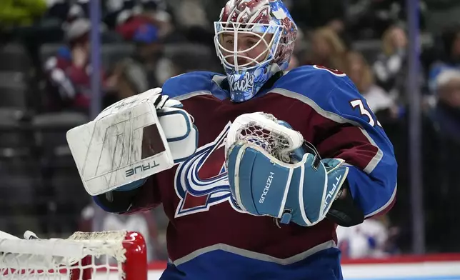 Colorado Avalanche goaltender Mackenzie Blackwood pulls on his gloves as a time out ends in the second period of an NHL hockey game against the New York Rangers, Tuesday, Jan. 14, 2025, in Denver. (AP Photo/David Zalubowski)