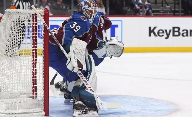 Colorado Avalanche goaltender Mackenzie Blackwood deflects the puck in the second period of an NHL hockey game against the New York Rangers Tuesday, Jan. 14, 2025, in Denver. (AP Photo/David Zalubowski)