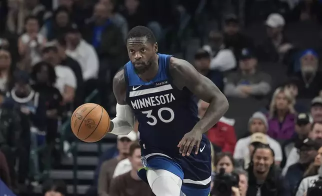 Minnesota Timberwolves forward Julius Randle (30) dribbles during the first half of an NBA basketball game against the Dallas Mavericks Wednesday, Jan. 22, 2025, in Dallas. (AP Photo/LM Otero)