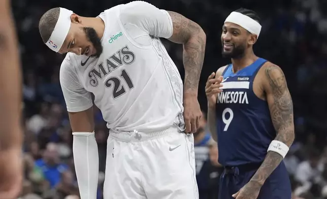 Dallas Mavericks center Daniel Gafford (21) dips his head in front of Minnesota Timberwolves guard Nickeil Alexander-Walker (9) during the second half of an NBA basketball game Wednesday, Jan. 22, 2025, in Dallas. (AP Photo/LM Otero)