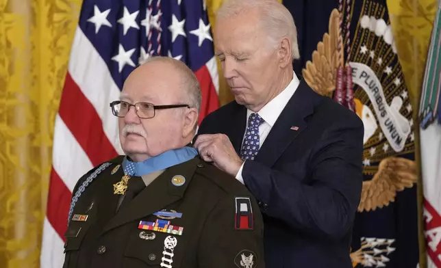 President Joe Biden presents the Medal of Honor, the nation's highest military decoration, to then-Private First Class Kenneth J. David, during a ceremony in the East Room of the White House in Washington, Friday, Jan. 3, 2025. (AP Photo/Susan Walsh)