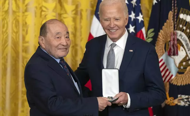 President Joe Biden awards the Presidential Citizens Medal to Wayne Tsutsumi on behalf of Mitsuye Endo Tsutsumi during a ceremony in the East Room at the White House, Thursday, Jan. 2, 2025, in Washington. (AP Photo/Mark Schiefelbein)