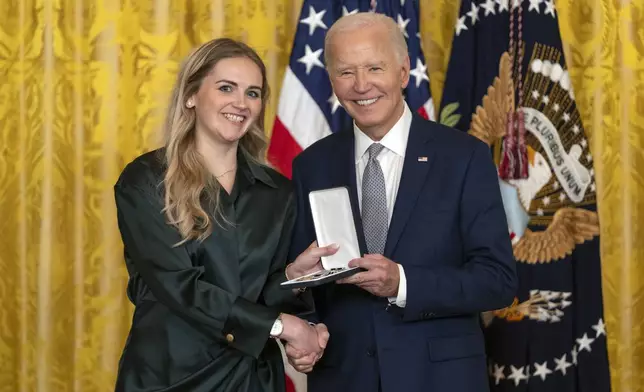 President Joe Biden awards the Presidential Citizens Medal to Grace McCarthy on behalf of Carolyn McCarthy during a ceremony in the East Room at the White House, Thursday, Jan. 2, 2025, in Washington. (AP Photo/Mark Schiefelbein)