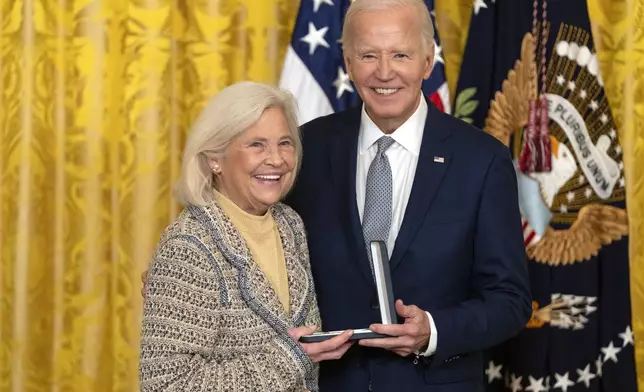 President Joe Biden awards the Presidential Citizens Medal to Cynthia Baker on behalf of Nancy Kassebaum during a ceremony in the East Room at the White House, Thursday, Jan. 2, 2025, in Washington. (AP Photo/Mark Schiefelbein)