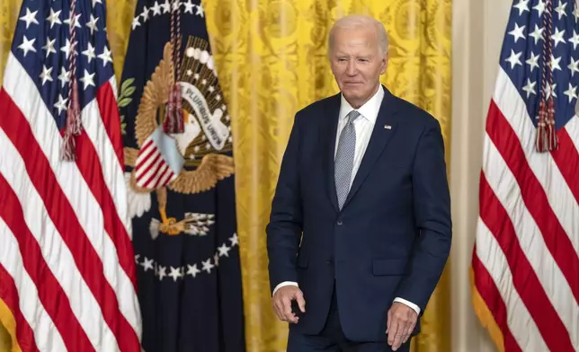 President Joe Biden stands during an event to award the Presidential Citizens Medal to recipients in the East Room at the White House, Thursday, Jan. 2, 2025, in Washington. (AP Photo/Mark Schiefelbein)