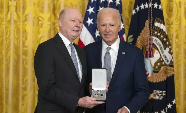 President Joe Biden awards the Presidential Citizens Medal to Collins Seitz, Jr., on behalf of Collins Seitz during a ceremony in the East Room at the White House, Thursday, Jan. 2, 2025, in Washington. (AP Photo/Mark Schiefelbein)