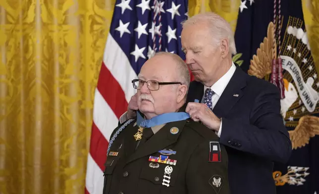 President Joe Biden presents the Medal of Honor, the nation's highest military decoration, to then-Private First Class Kenneth J. David, during a ceremony in the East Room of the White House in Washington, Friday, Jan. 3, 2025. (AP Photo/Susan Walsh)