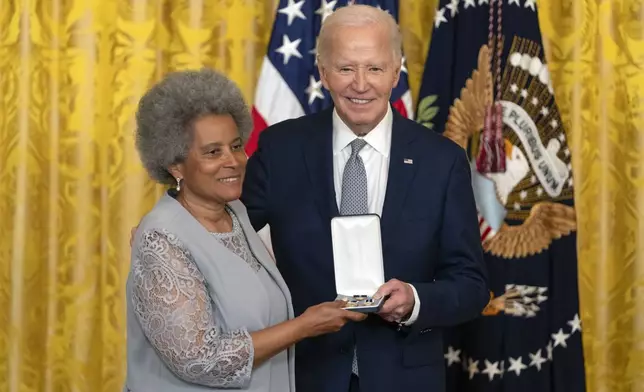 President Joe Biden awards the Presidential Citizens Medal to Rupa Redding-Lallinger on behalf of Louis Redding during a ceremony in the East Room at the White House, Thursday, Jan. 2, 2025, in Washington. (AP Photo/Mark Schiefelbein)