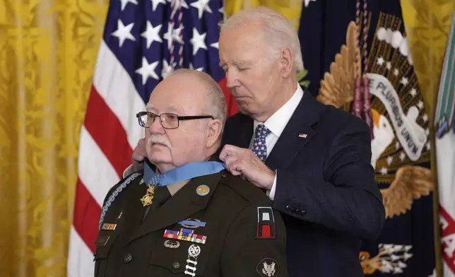 President Joe Biden presents the Medal of Honor, the nation's highest military decoration, to then-Private First Class Kenneth J. David, during a ceremony in the East Room of the White House in Washington, Friday, Jan. 3, 2025. (AP Photo/Susan Walsh)