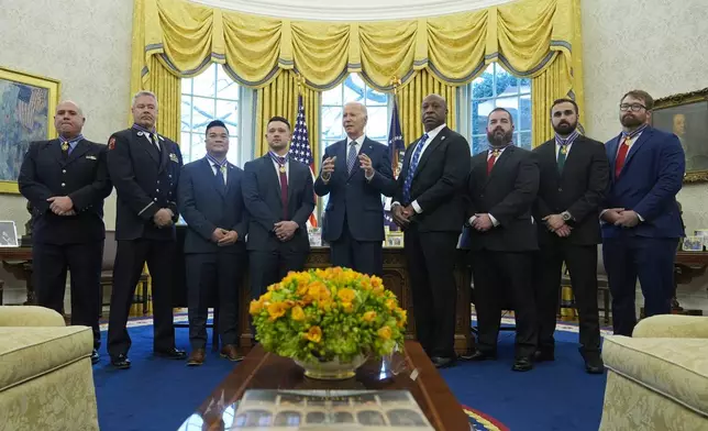 President Joe Biden, center, poses for a photo with Medal of Valor honorees in the Oval Office of the White House in Washington, Friday, Jan. 3, 2025. Honorees are, from left, Lt. John Vanderstar of the New York City Fire Department, Firefighter Brendan Gaffney of the New York City Fire Department, Sgt. Tu Tran, of the Lincoln, Neb. Police Department, Det. Michael Collazo, of the Nashville, Tenn. Police Department, Chief John Drake, receiving on behalf of Officer Rex Engelbert, of the Nashville, Tenn. Police Department, Sgt. Jeffrey Mathes, of the Nashville, Tenn. Police Department, Det. Zachary Plese, of the Nashville, Tenn. Police Department, and Det. Ryan Cagle, of the Nashville, Tenn. Police Department. (AP Photo/Susan Walsh)