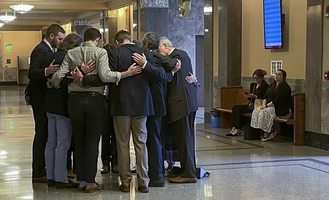 FILE - Covenant School parents and their attorneys huddle in prayer outside a courtroom before a hearing to decide whether documents and journals of a Nashville school shooter can be released to the public, April 17, 2024, in Nashville, Tenn. (AP Photo/Travis Loller, File)