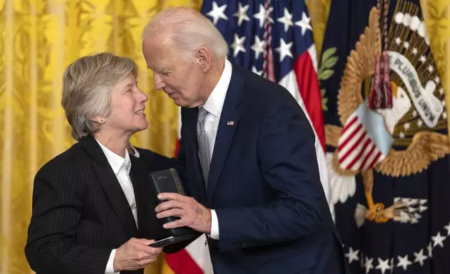 CORRECTS SPELLING OF LAST NAME TO BONAUTO, NOT BONUATO - President Joe Biden awards the Presidential Citizens Medal to Mary Bonauto during a ceremony in the East Room at the White House, Thursday, Jan. 2, 2025, in Washington. (AP Photo/Mark Schiefelbein)