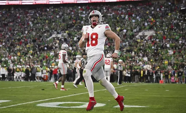 Ohio State quarterback Will Howard (18) reacts after a touchdown against Oregon during the second half in the quarterfinals of the Rose Bowl College Football Playoff, Wednesday, Jan. 1, 2025, in Pasadena, Calif. (AP Photo/Kyusung Gong)