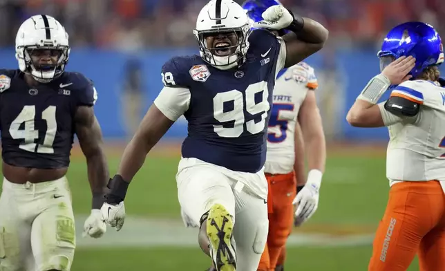 Penn State defensive tackle Coziah Izzard (99) celebrates a defensive stop against Boise State during the second half of the Fiesta Bowl College Football Playoff game, Tuesday, Dec. 31, 2024, in Glendale, Ariz. (AP Photo/Ross D. Franklin)