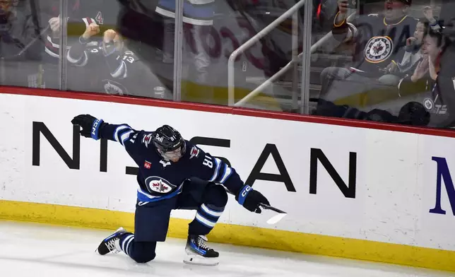 Winnipeg Jets' Kyle Connor (81) celebrates his goal against the Calgary Flames during the first period of an NHL hockey game in Winnipeg, Manitoba, Sunday, Jan. 26, 2025. (Fred Greenslade/The Canadian Press via AP)