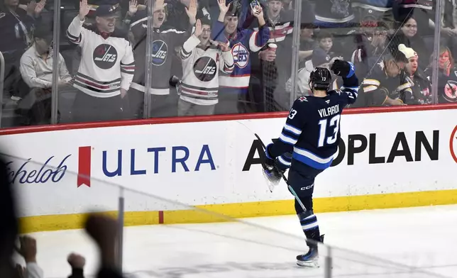 Winnipeg Jets' Gabriel Vilardi (13) celebrates his goal against the Calgary Flames during the third period of an NHL hockey game in Winnipeg, Manitoba, Sunday, Jan. 26, 2025. (Fred Greenslade/The Canadian Press via AP)