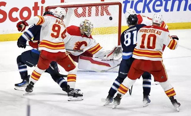 Winnipeg Jets Gabriel Vilardi scores on Calgary Flames goaltender Dan Vladar during the third period of an NHL hockey game in Winnipeg, Manitoba, Sunday, Jan. 26, 2025. (Fred Greenslade/The Canadian Press via AP)
