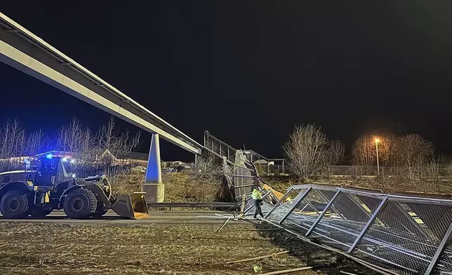 This image provided by the Alaska Department of Transportation &amp; Public Facilities shows fencing and the roof of a walkway after collapsing onto the Seward Highway in Anchorage, Alaska, on Sunday, Jan. 12, 2025. (Alaska Department of Transportation &amp; Public Facilities via AP)