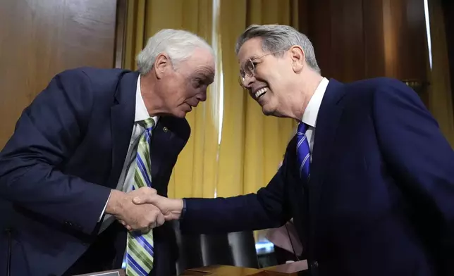 Sen. Ron Johnson, R-Wis., left, greets Scott Bessent, right, President-elect Donald Trump's choice to be secretary of the Treasury, before the Senate Finance Committee for Bessent's confirmation hearing, at the Capitol in Washington, Thursday, Jan. 16, 2025. (AP Photo/J. Scott Applewhite)