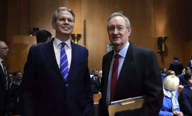 Scott Bessent, right, President-elect Donald Trump's choice to be secretary of the Treasury, talks with Chairman Mike Crapo, R-Idaho, before the Senate Finance Committee for his confirmation hearing, at the Capitol in Washington, Thursday, Jan. 16, 2025. (AP Photo/J. Scott Applewhite)
