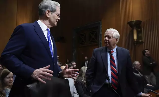 Scott Bessent, left, President-elect Donald Trump's choice to be Secretary of the Treasury, arrives with Sen. Lindsey Graham, R-S.C., right, before the Senate Finance Committee for his confirmation hearing, at the Capitol in Washington, Thursday, Jan. 16, 2025. (AP Photo/J. Scott Applewhite)