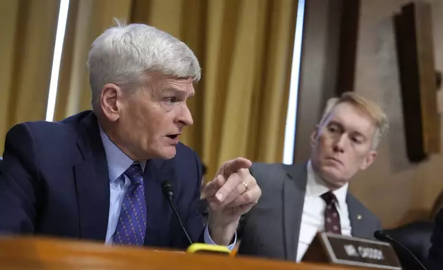 Sen. Bill Cassidy, R-La., left, speaks as Sen. James Lankford, R-Okla., right, listens at the Senate Finance Committee confirmation hearing for Scott Bessent, President-elect Donald Trump's choice to be Secretary of the Treasury, at the Capitol in Washington, Thursday, Jan. 16, 2025. (AP Photo/Ben Curtis)