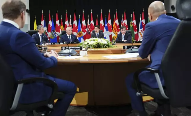 Canada Prime Minister Justin Trudeau, back center, and premiers attend the first ministers meeting in Ottawa on Wednesday, Jan. 15, 2025. (Sean Kilpatrick/The Canadian Press via AP)