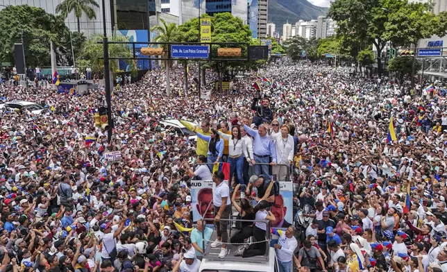 FILE - Opposition leader Maria Corina Machado and opposition candidate Edmundo Gonzalez ride atop a truck during a protest against official presidential election results declaring President Nicolas Maduro the winner in Caracas, Venezuela, July 30, 2024, two days after the vote. (AP Photo/Matias Delacroix, File)