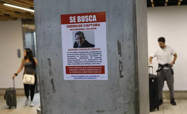 A wanted poster of Venezuela's opposition leader Edmundo Gonzalez covers a column at the Simon Bolivar International Airport in Maiquetia, near Caracas, Venezuela, Friday, Jan. 3, 2025. (AP Photo/Cristian Hernandez)