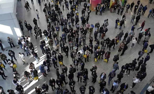 People wait to enter the show floor during the CES tech show Tuesday, Jan. 7, 2025, in Las Vegas. (AP Photo/John Locher)