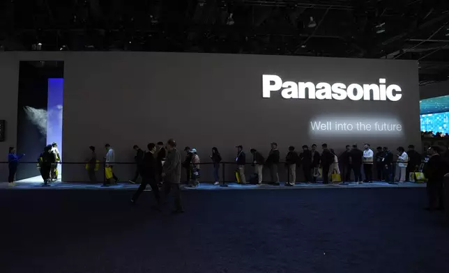 People wait in line to enter a Panasonic booth during the CES tech show Tuesday, Jan. 7, 2025, in Las Vegas. (AP Photo/Abbie Parr)