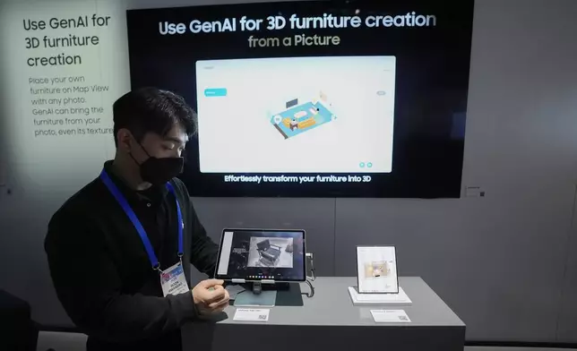 A Samsung employee shows how electronics using the Connected Home Experience powered by Samsung SmartThings uses GenAI for 3D furniture creation at a Samsung booth during the CES tech show Tuesday, Jan. 7, 2025, in Las Vegas. (AP Photo/Abbie Parr)