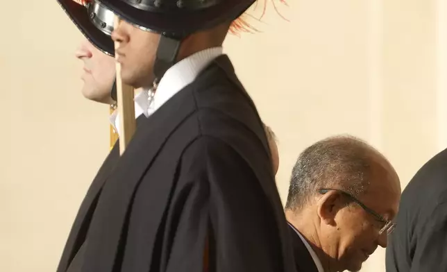 Leslie Voltaire, the president of Haiti's Transition Council, walks past Vatican Swiss guards ahead of his meeting with Pope Francis at the Vatican, Saturday, Jan. 25, 2025. (AP Photo/Gregorio Borgia)