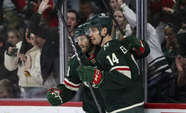 Minnesota Wild center Joel Eriksson Ek, right, celebrates his goal with right wing Ryan Hartman during the second period of an NHL hockey game against the St. Louis Blues, Tuesday, Jan. 7, 2025, in St. Paul, Minn. (AP Photo/Matt Krohn)