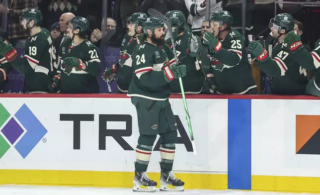 Minnesota Wild defenseman Zach Bogosian (24) is congratulated for his goal against the St. Louis Blues during the first period of an NHL hockey game Tuesday, Jan. 7, 2025, in St. Paul, Minn. (AP Photo/Matt Krohn)