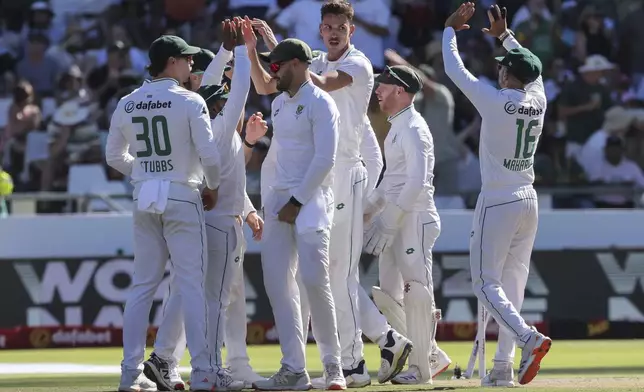 South Africa players celebrate the wicket of Pakistan's Kamran Ghulam during the second day of the second test match between South Africa and Pakistan in Cape Town, South Africa, Saturday, Jan. 4, 2025. (AP Photo/Halden Krog)