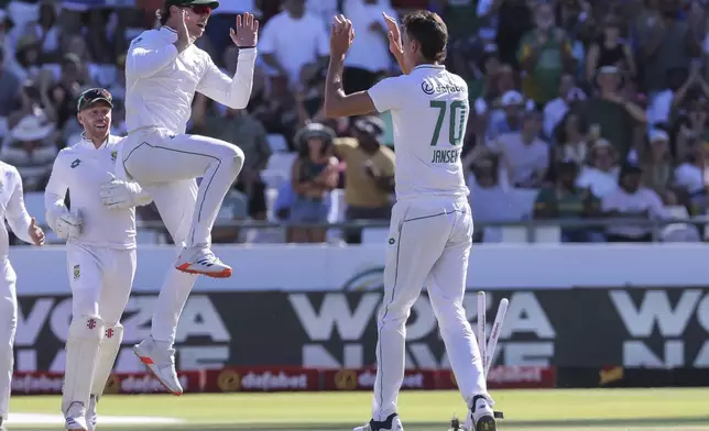 South Africa players celebrate the wicket of Pakistan's Kamran Ghulam during the second day of the second test match between South Africa and Pakistan in Cape Town, South Africa, Saturday, Jan. 4, 2025. (AP Photo/Halden Krog)