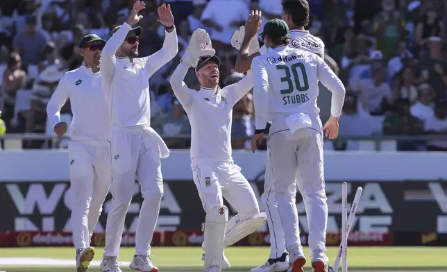 South Africa players celebrate the wicket of Pakistan's Kamran Ghulam during the second day of the second test match between South Africa and Pakistan in Cape Town, South Africa, Saturday, Jan. 4, 2025. (AP Photo/Halden Krog)