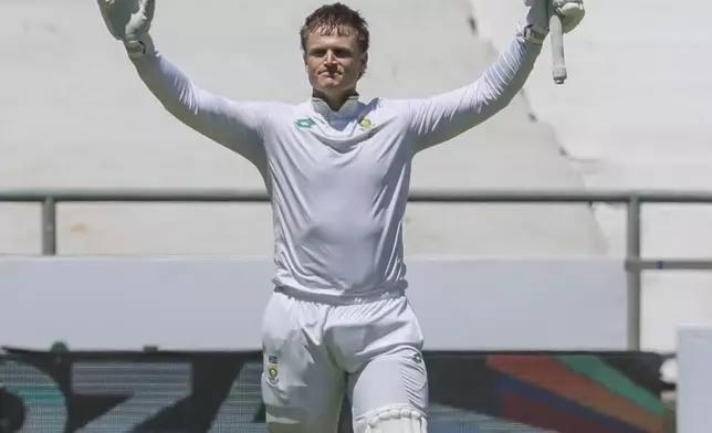 South Africa's Ryan Rickelton celebrates his 200 runs during the second day of the second test match between South Africa and Pakistan in Cape Town, South Africa, Saturday, Jan. 4, 2025. (AP Photo/Halden Krog)