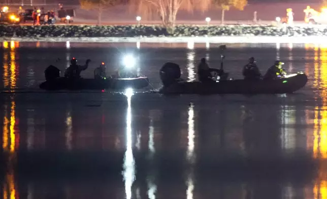 Boats work the scene in the Potomac River near Ronald Reagan Washington National Airport, Thursday, Jan. 30, 2025, in Arlington, Va. (AP Photo/Alex Brandon)