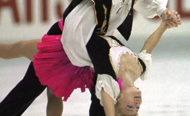 FILE - Evgenia Shishkova and Vadim Naumov of Russia perform during free skating in the pairs event of the NHK Trophy International Figure Skating Competition at Nagoya central Japan, Dec. 9, 1995. (AP Photo/Shizuo Kambayashi, File)