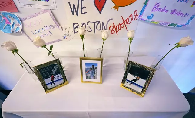 Six white roses and photographs of victims are displayed at The Skating Club of Boston, Thursday, Jan. 30, 2025, in Norwood, Mass. (AP Photo/Charles Krupa)