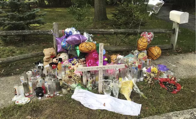 FILE - A memorial to best friends Nisa Mickens and Kayla Cuevas in Brentwood, N.Y., Sept. 27, 2016, near the spot where their bodies were found. (AP Photo/Claudia Torrens, File)